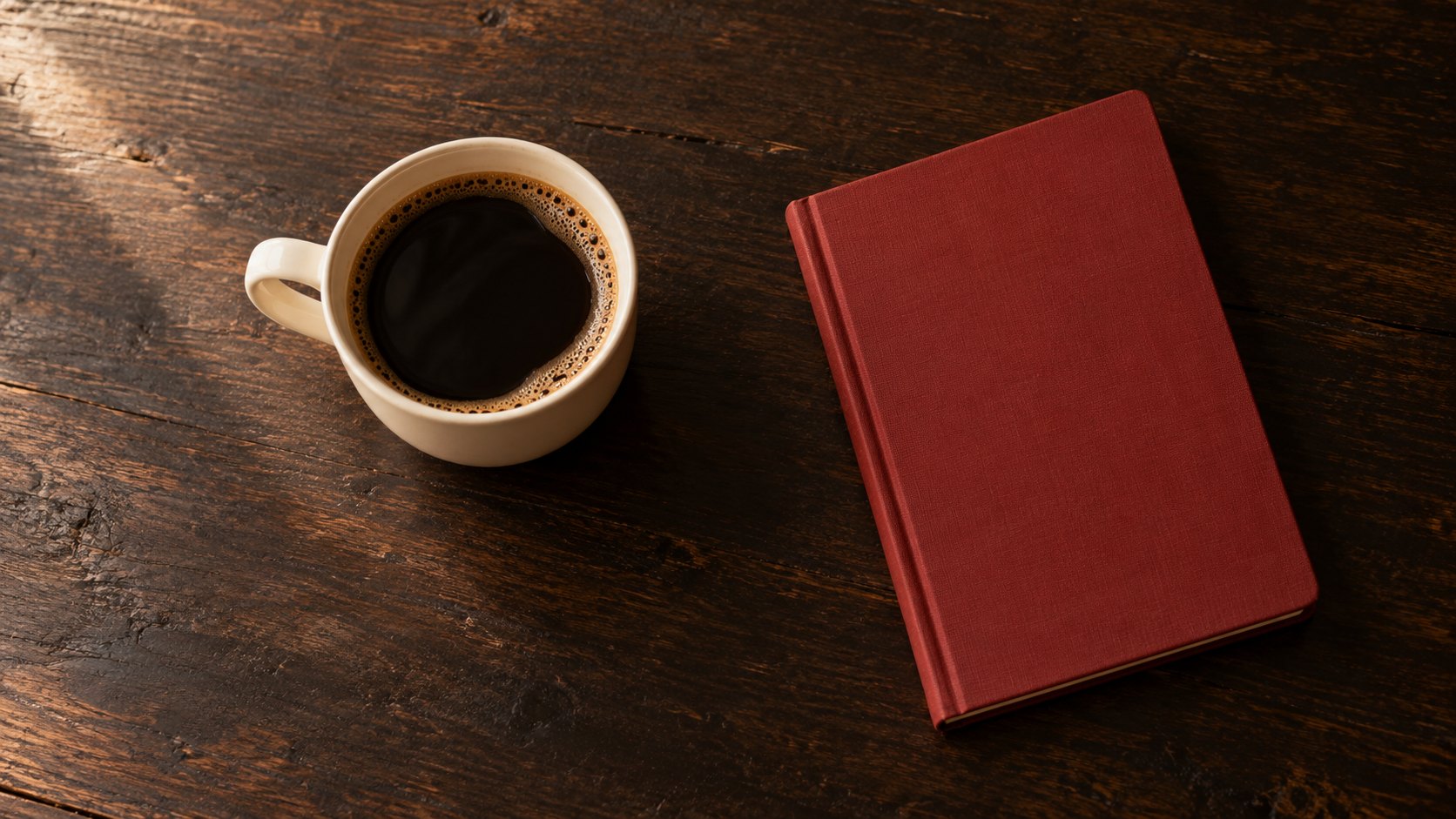 Coffee beside a closed notebook